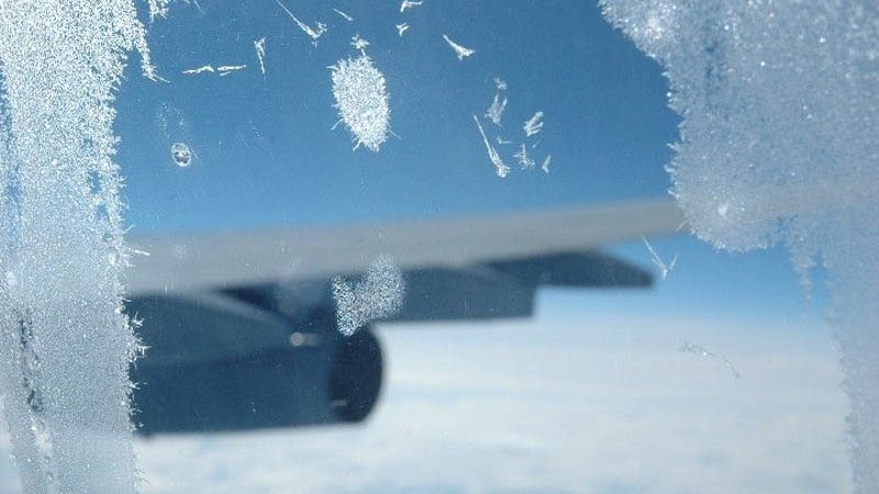 Ventanilla de avión con mucho hielo adherido, en ocasiones normales, no se forma tanta cantidad